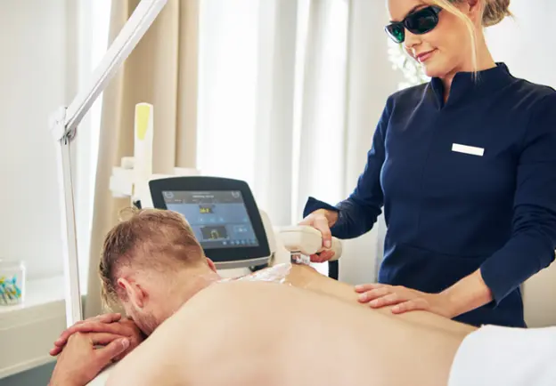 Male client receiving laser back hair removal treatment by a professional in Urban Body Laser in Vancouver, showcasing the procedure for effective hair reduction.