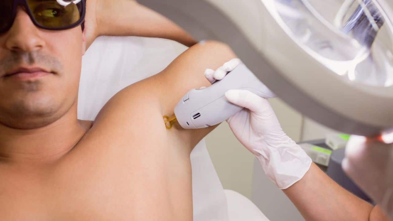 Man receiving laser hair removal treatment