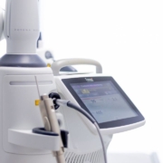 Close-up of a Fotona laser machine used for advanced skin and medical treatments, featuring a sleek touchscreen interface and precision handpiece.