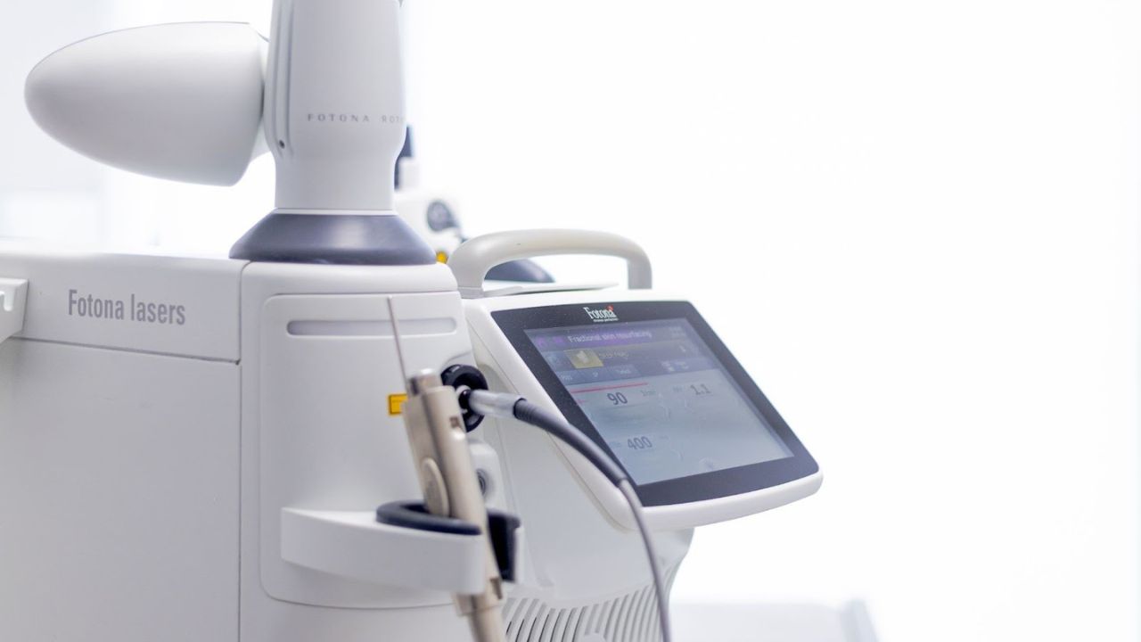 Close-up of a Fotona laser machine used for advanced skin and medical treatments, featuring a sleek touchscreen interface and precision handpiece.