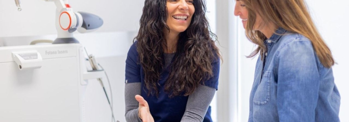 Professional explaining IPL treatment steps to a satisfied customer during consultation