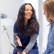 Professional explaining IPL treatment steps to a satisfied customer during consultation