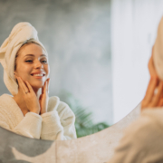 Woman at home applying cream mask Woman at home applying cream mask