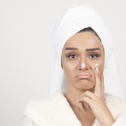 Beautiful young woman in a white bathrobe posing on a white wall Beautiful young woman in a white bathrobe posing on a white wall