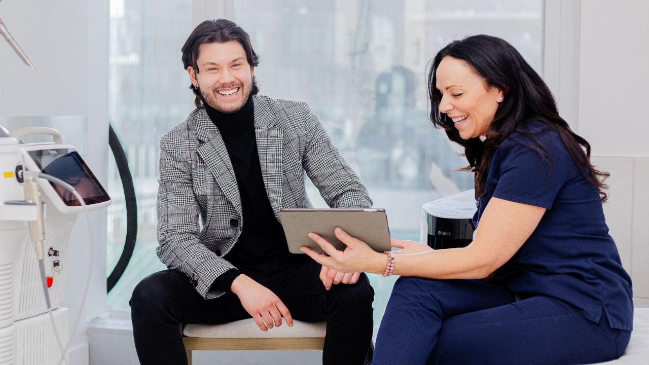 Happy customer during consultation with a skincare professional in a medical aesthetics clinic